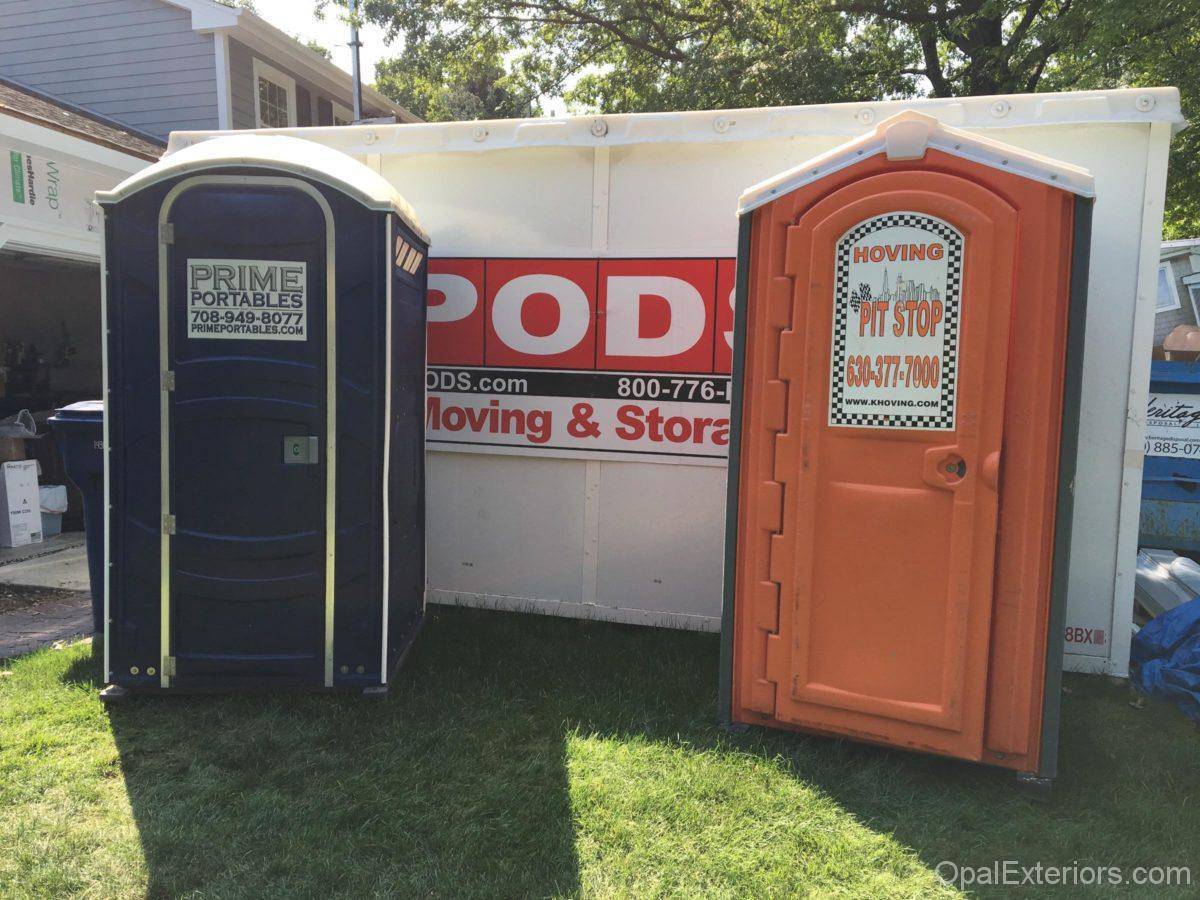 Porta Potty and building supplies on job site