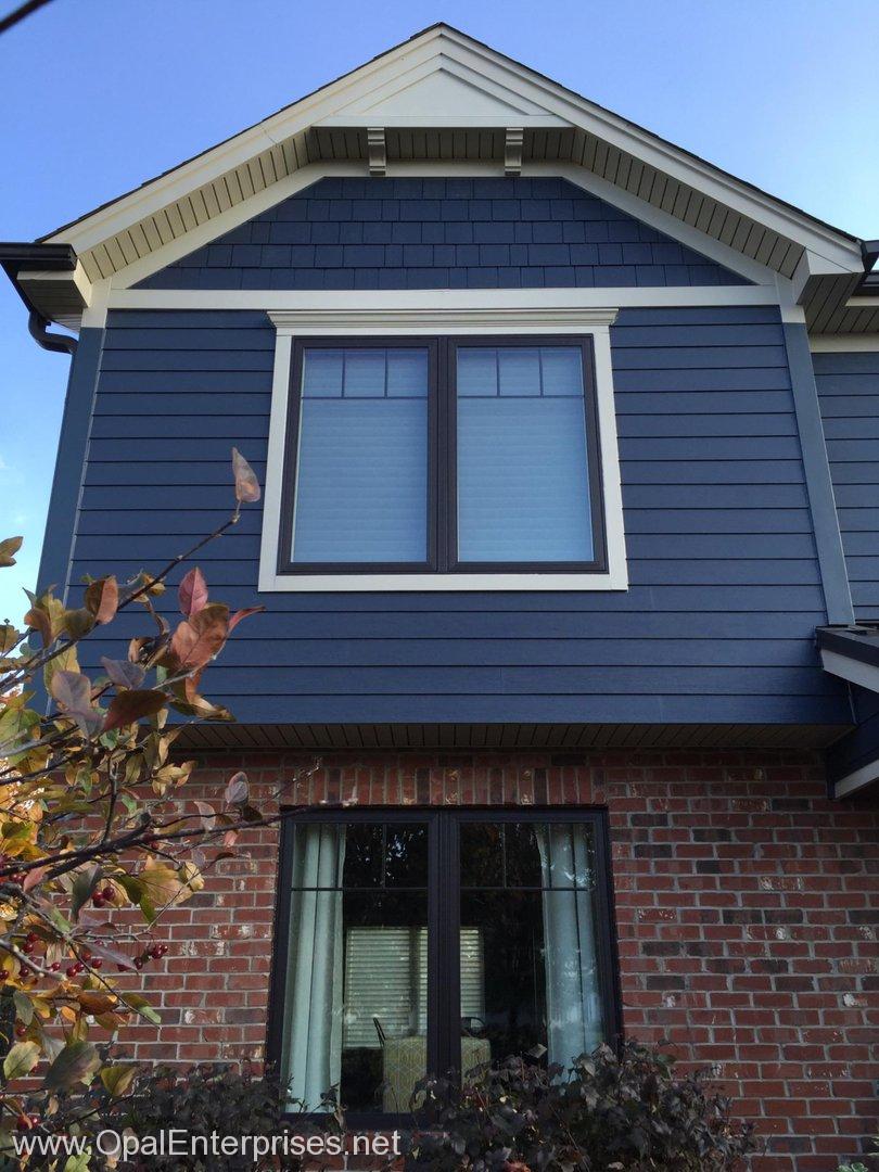 Deep Ocean James Hardie Siding paired with brick & Andersen Windows